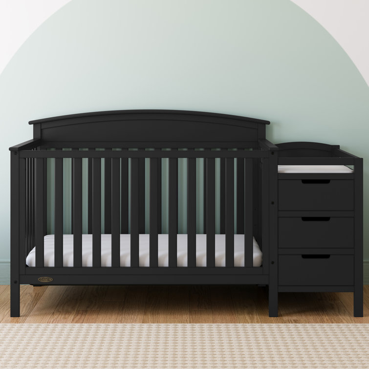 Grey crib with attached changing outlet table